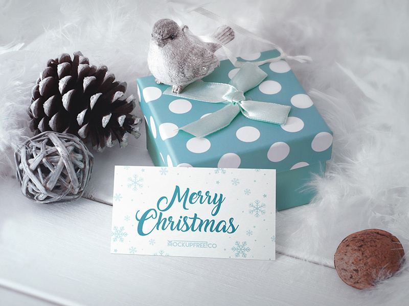 Business Card in Christmas Scenery – Free PSD Mockup mockups product free mockup pinecone nuts gift feathers christmas business card bird