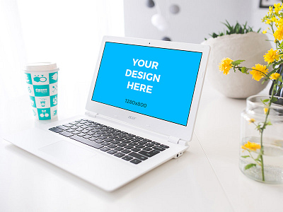 White laptop on white table with coffee