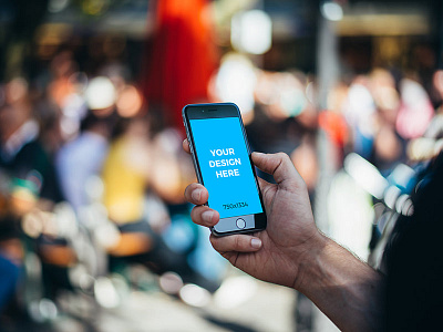 Man in the street holding black iPhone 6S