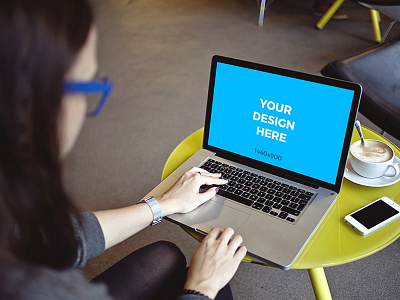 Woman working on MacBook Pro in coworking space - Free Mockup