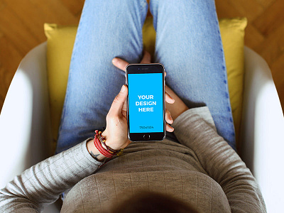 Woman sitting in a chair with iPhone 6S - Free Mockup