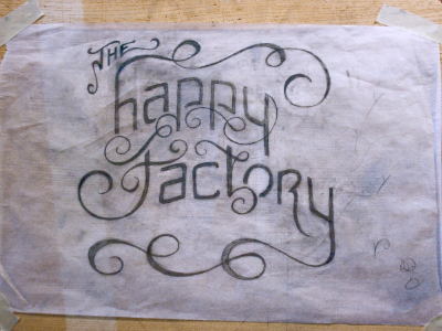 We create happy. hand drawn logo typography wood