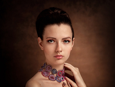 Portrait of a beautiful girl in a red dress and in beaded beads studio vintage