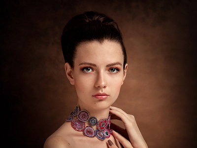 Portrait of a beautiful girl in a red dress and in beaded beads