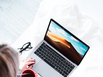 woman using her laptop in bed