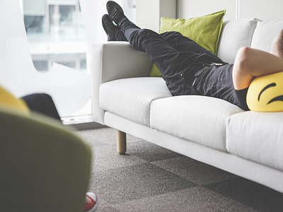 young man napping on white sofa in the offert