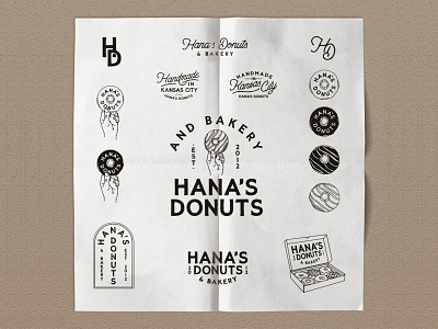 Hanna's Donuts branding custom design donut donut box donut design donut pattern donuts hand hand drawn handmade hands holding illustration logo paper pattern pattern t-shirt typography wax paper
