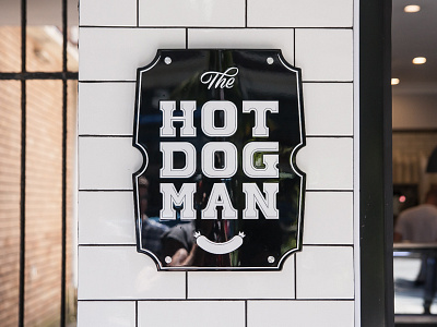 The HOTDOGMAN branding done and dusted hot dogs lettering logo