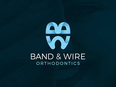 Dentist logo with monogram forming a tooth icon