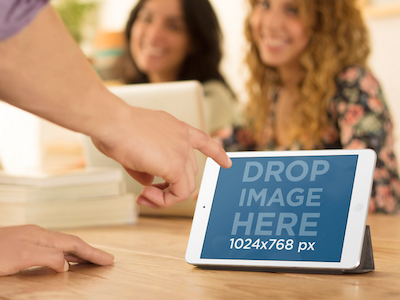 iPad Mini Mockup of Man Using White iPad at the Office