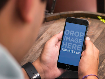 Black iPhone 6 Mockup Featuring a Young Man at a Bar