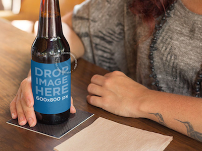 Label Mockup of a Tattooed Woman Having a Beer at a Bar