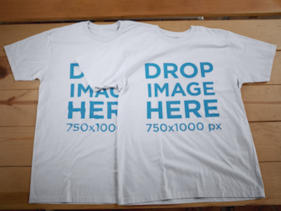 T-Shirt Mockup of Two T-Shirts Lying on a Wooden Table
