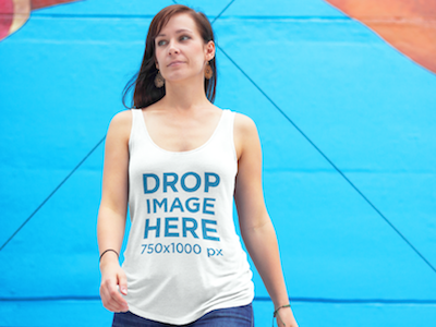 Tank Top Mockup of a Woman With a Blue Wall Behind Her clothing mockup template content marketing digital marketing marketing tools mockup tools stock photo mockup stock photo template tank top mockup tank top mockup generator tank top mockup template tank top template visual marketing tools