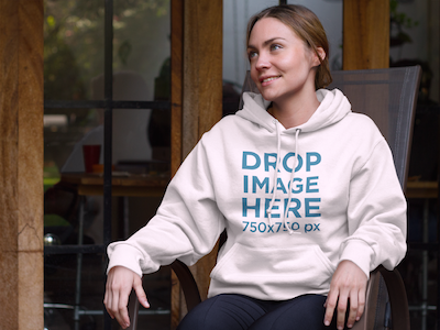 Hoodie Mockup Featuring a Girl Sitting in a Porch