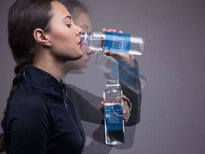 Motion Photo Mockup of a Young Woman Drinking Water bottle mockup bottle template digital marketing label mockup label stock photo label template online marketing tools stock photo template ux design web marketing wine bottle mockup wine bottle template