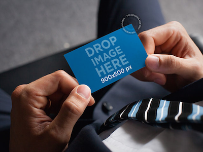 Mockup of a Businessman Holding a Business Card