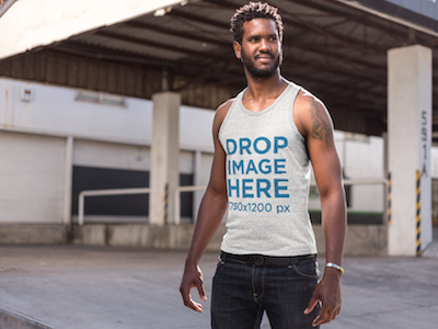 Tank Top Mockup of a Man Standing Outside a Warehouse