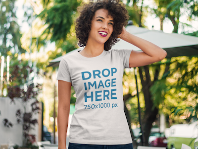 Curly-Haired Woman Standing Outside a Cafe T-Shirt Mockup
