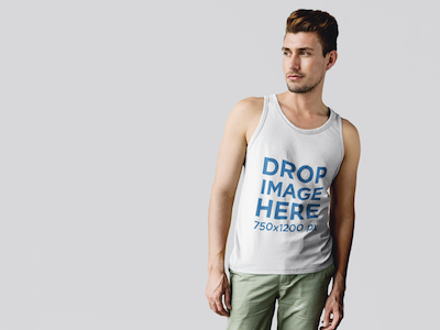 Tank Top Mockup of a Guy Standing in Front of a White Wall