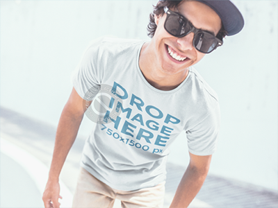 T-Shirt Mockup of a Guy Smiling at a Skatepark