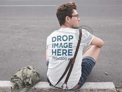 Tee Mockup Featuring a Young Hipster Man Sitting on a Sidewalk apparel clothing clothing brand clothing mockups marketing mockups t shirt tshirt tshirt mockup