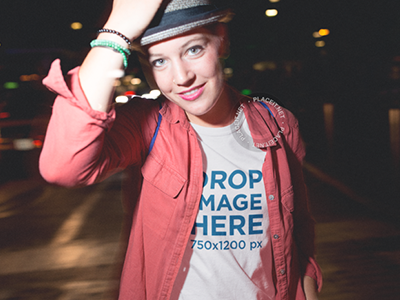 Mockup of a Stylish Woman Wearing a Tee and Hat Out at Night