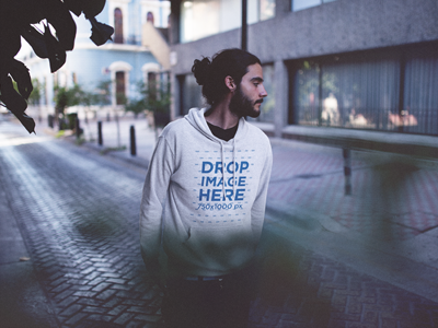 Hoodie Mockup featuring a Young Man in the Street