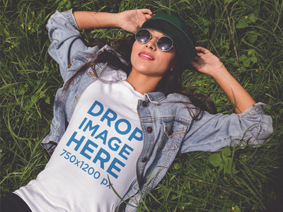 Mockup of a Trendy Girl Wearing a T-Shirt Lying in the Grass apparel clothing clothing brand clothing mockups marketing mockups t shirt tshirt tshirt mockup