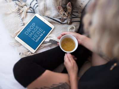 iPad Mockup of a Young Woman Having a Cup of Tea With Her Kitten