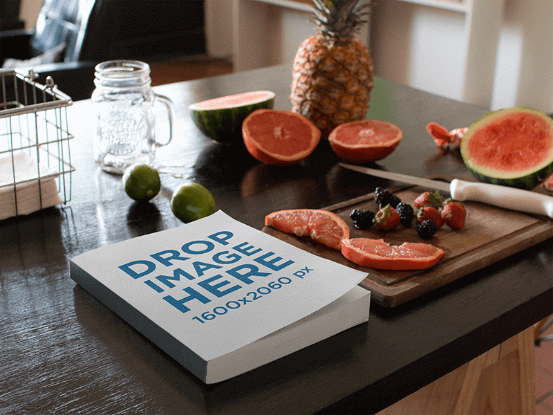 Book Lying on a Kitchen Table Next to Fruits and Knife Mockup book book mockups ebook mockup ebook mockup generator ebook stock photo ebook template image marketing mockup photorealistic mockup selfpublishing template web marketing
