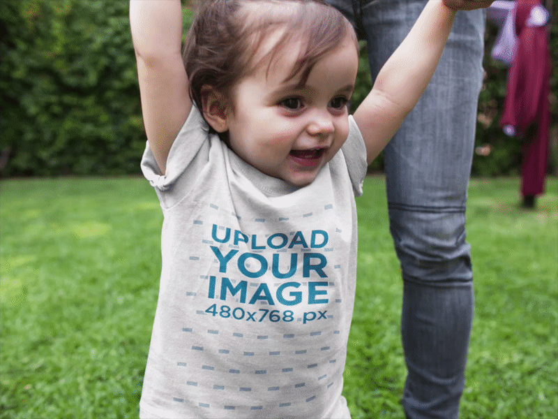 Baby Walking in the Park Wearing a Round Neck Tee Mockup baby t shirt baby tee design graphic t shirt group t shirt mockup generator t shirt t shirt design t shirt mockup tee toddler mockup toddler t shirt toddler tee