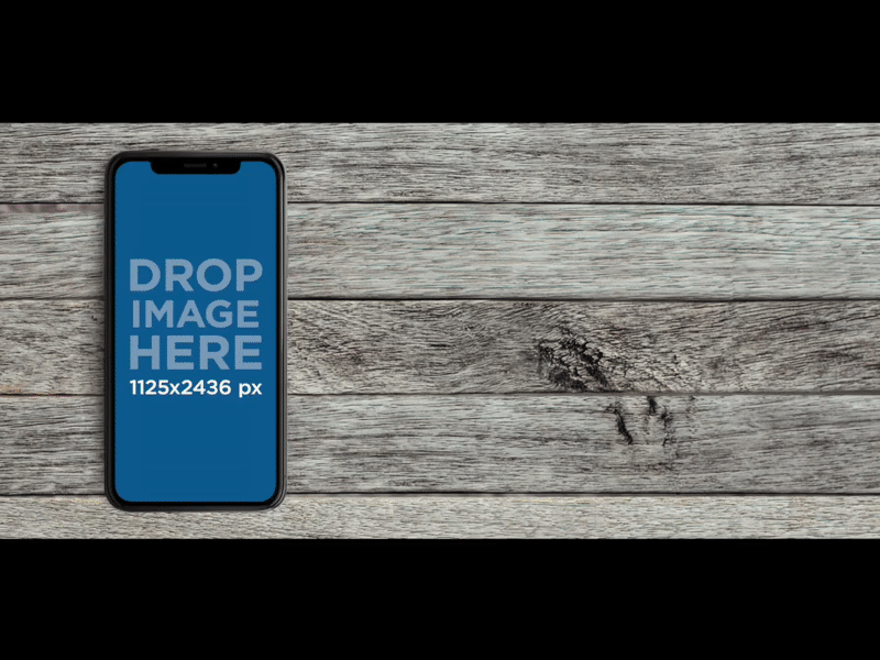 iPhone X Mockup Lying Over a Gray Wooden Surface
