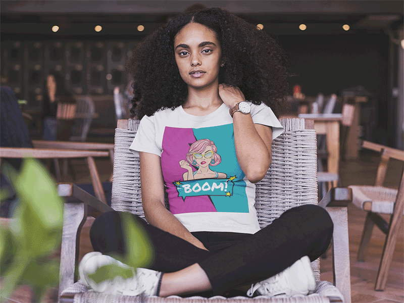 Black Woman Wearing a T-Shirt Mockup Sitting on a Wooden Chair design template mockup t shirt t shirt design