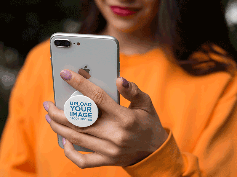 PopSocket Mockup Featuring a Woman in an Orange Sweatshirt design mockup digital marketing industrialdesign mockup generator mockup template mockup tools pop socket stock photo mockup web marketing