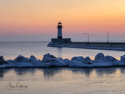 Sunrise at North Pier Lighthouse branding duluth harbor lighthouse lighthouse logo logo minnesota photography travel travel app travel branding