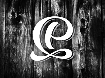 QP black handlettering logo photography script white wood