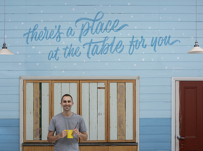 ‘A Place at the Table’ Complete Mural community hand lettering lettering mural mural painting muralist paint pattern script lettering type typography welcome