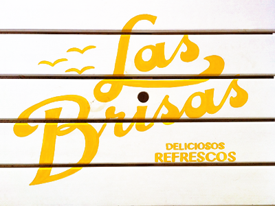 Las Brisas branding enamel sign lettering logotype picnic table script soda yellow