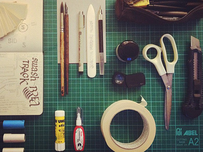 Tools book creative creativity cut board equipment glue graphic design grid illustration ink markers materials moleskine paper pencils pens posca ready ruler scissors spray can tape toolkit tools tools of the trade top view workspace