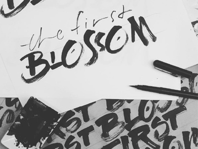 Work in progress for an event logo black brush calligraphy logo the first blossom wip