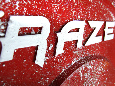 RAZE Logo on a Cast Iron Weight Plate brand identity branding fitness logo logo design raze strength weights