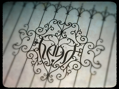 Iron heart ambigram filegree heart lettering mirror ornamentation wrought iron