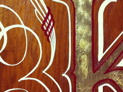 Gilded K analog lettering sign painting