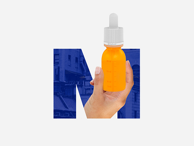 Hand holding a bottle inside the letter M