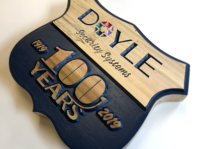 Doyle 100th Anniversary Logo on Wood 100 anniversary branding centennial corporate branding doyle identity illustrator logo logo design security wood wood block