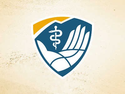 Rocky Mountain University – Shield Logo asclepius college crest hand health healthcare mountain rocky mountain school shield snake university