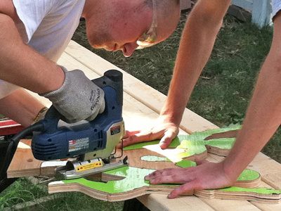 CURE event booth sign construction cure.org green handmade lime physical sign wood