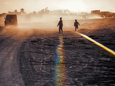 Rainbow kids play in the sand