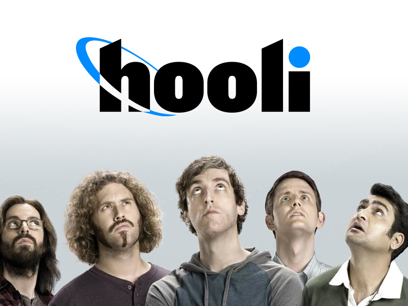 Picture of the cast of Silicon Valley, concerned, looking up at the logo of Hooli